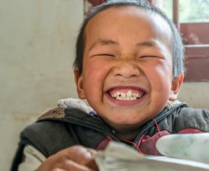 Image of a grinning child with a book