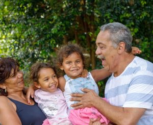 Indigenous family smiling with help from workplace giving